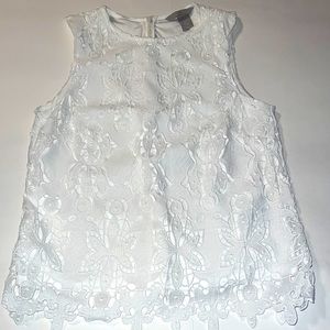 Gorgeous H&M white sleeveless blouse with white lining.